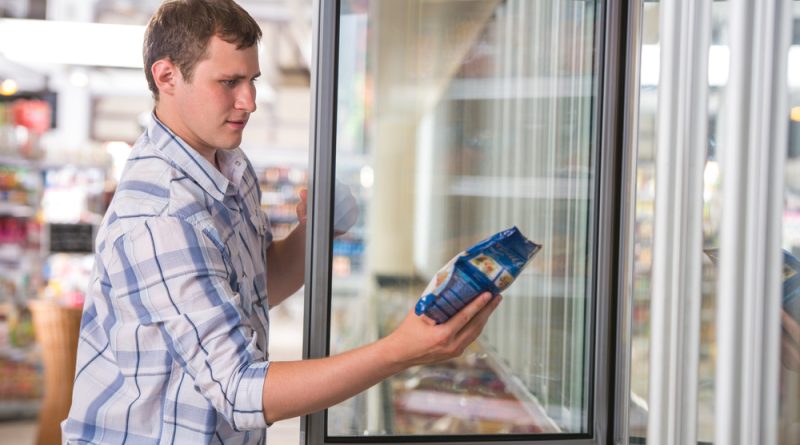 A man in the supermarket shopping frozen food
