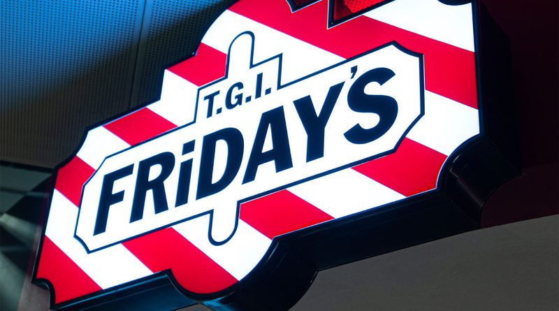 Close up mage of the TGI Friday's sign fixed to a dark wall to support tgi fridays boneless chicken bites article