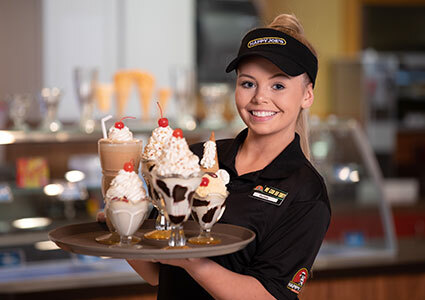 Waitress with a tray of ice cream desserts