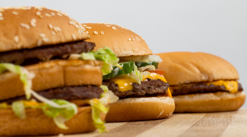Three different Mcdonald's burger lined up in a row to support AI cashiers article