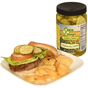 Jar of pickles next to a burger & crisps