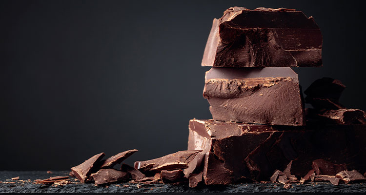 Chunks of dark chocolate stacked on top of each other