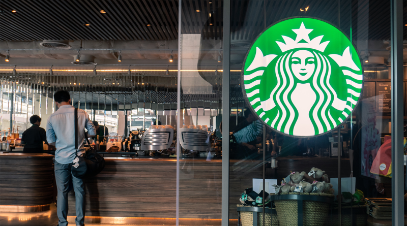 Starbucks store front with customer inside getting free refill