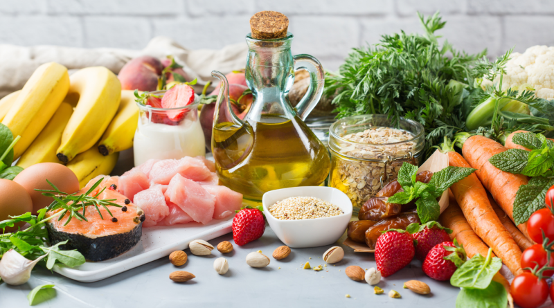 A variety of fresh Mediterranean diet ingredients including olive oil, fish, vegetables, and whole grains