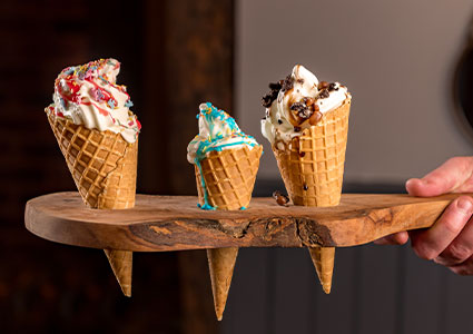 3 gelato cones served in a wooden board