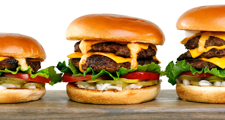 Row of three different cheeseburgers