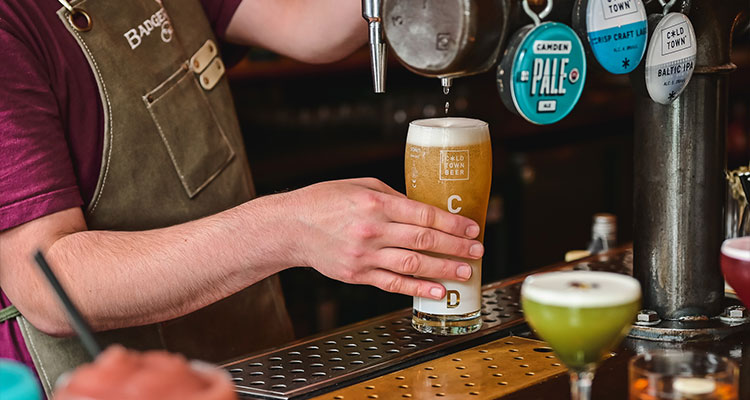 Pint of craft beer being poured in a bar