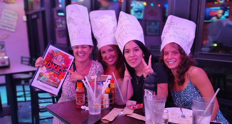 four women at a restaurant known as Dick's Last Resort.