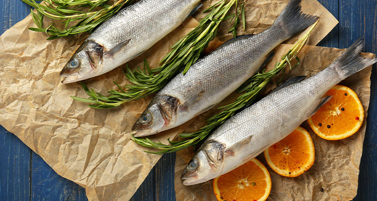 several whole fish, prepared with oranges and herbs