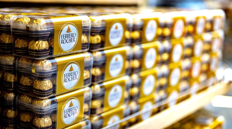 Ferrero nears multi billion dollar deal that could reshape cereal market Alt Text: Stacks of Ferrero Rocher chocolate boxes neatly displayed on a store shelf, featuring the brand's signature gold and brown packaging.