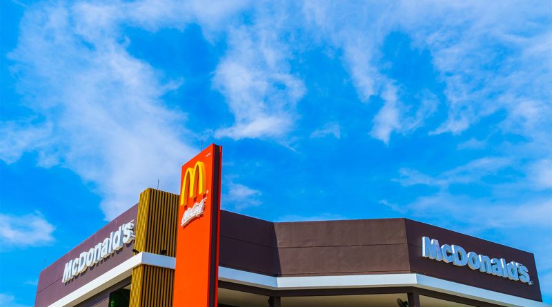 Krispy Kreme doughnuts displayed at a McDonald's counter with a sign announcing the partnership’s end in 2025.