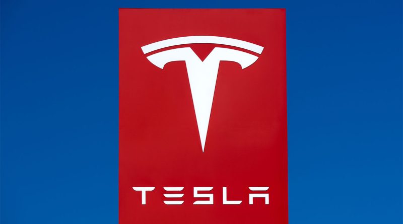 The full Tesla Diner menu has now been revealed Tesla logo on a bright red sign against a clear blue sky, representing the brand’s presence and identity