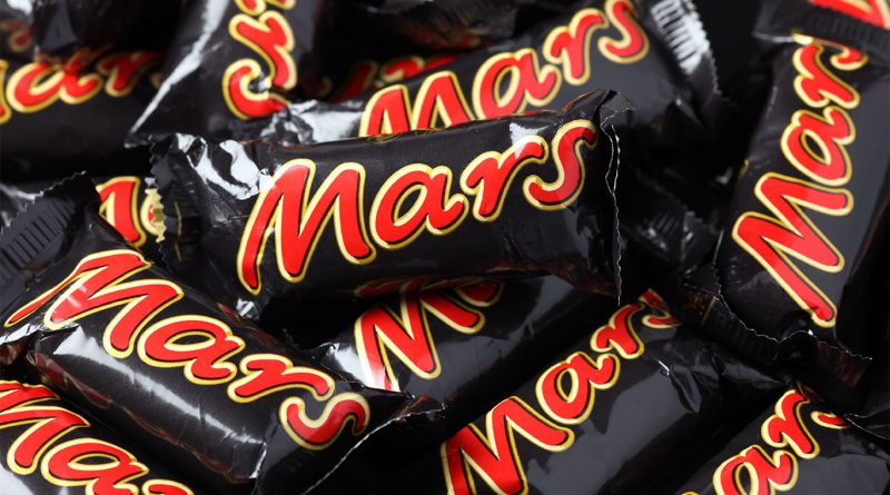 Snickers maker Mars to invest $2B in US manufacturing through 2026 Exterior view of a Mars Wrigley U.S. manufacturing facility with Snickers branding on display.