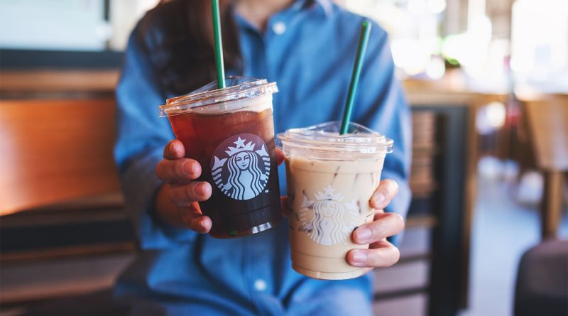 Starbucks pushes into protein coffee trend as food industry faces shift Starbucks barista serving a protein latte with branded cup on a wooden café counter