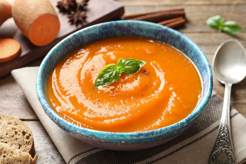 Bowl of Spiced sweet potato and carrot soup for Fall Soup Recipes article