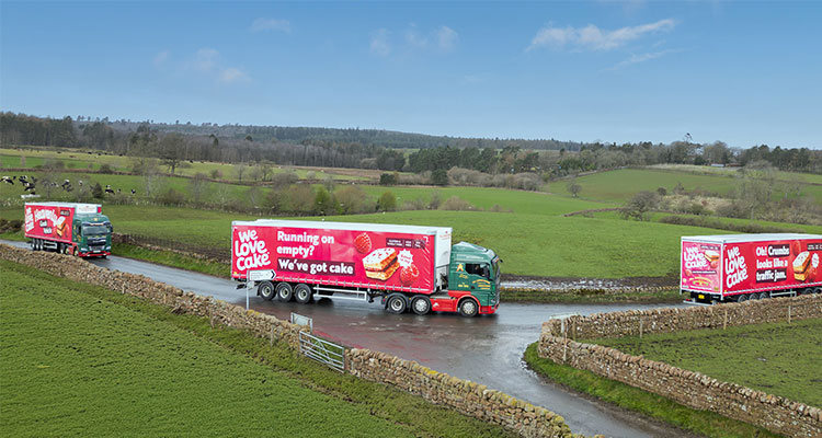 3 Bells of Lazomby trucks bearing the slogan We Love Cake