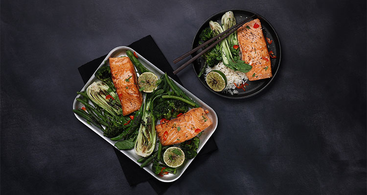 tray-baked salmon featuring salmon fillets paired with vegetables