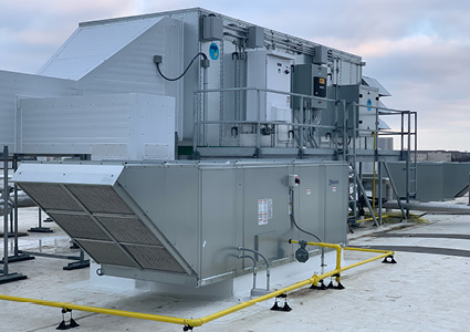 a large, complex industrial evaporative cooling and ventilation system installed on a rooftop.