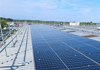 a large-scale commercial solar photovoltaic (PV) installation on a flat roof