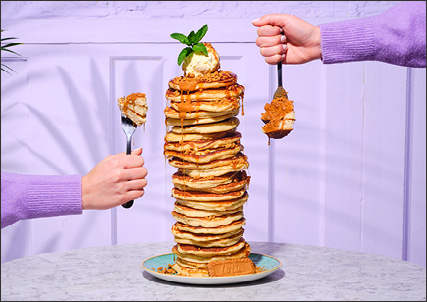 a towering stack of Bill's Lotus Biscoff pancakes