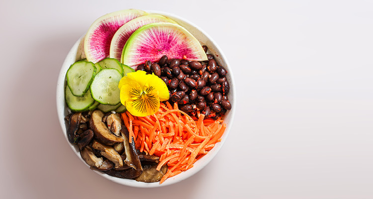 a Buddha bowl featuring a vibrant medley of fresh vegetables and proteins