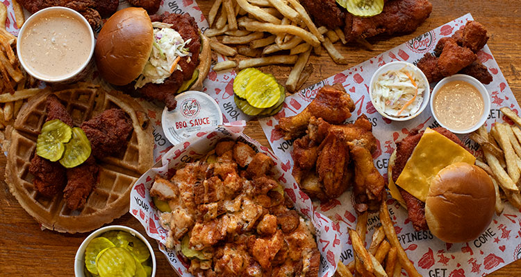 a comprehensive spread from Fry the Coop, featuring their signature Nashville Hot Chicken alongside fries and coleslaw