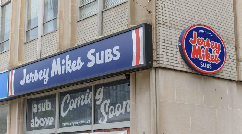 Customers ordering sandwiches inside a Jersey Mike's restaurant location.