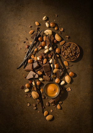 a stylized, overhead culinary photograph featuring an artistic arrangement of dessert and baking ingredients