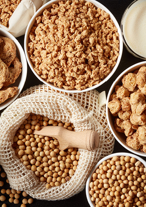 various soy products, including raw soybeans, textured vegetable protein (TVP) chunks, and soy milk