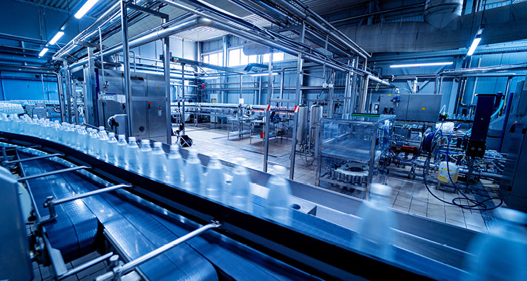 an automated conveyor belt system inside a modern beverage and water bottling plant