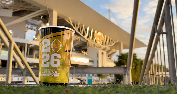 a souvenir cup from the 2026 College Football Playoff National Championship, positioned in front of Hard Rock Stadium