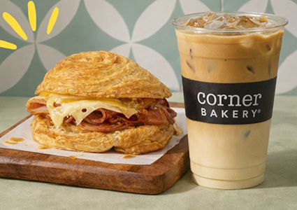 an iced coffee from Corner Bakery Cafe paired with a savory breakfast sandwich
