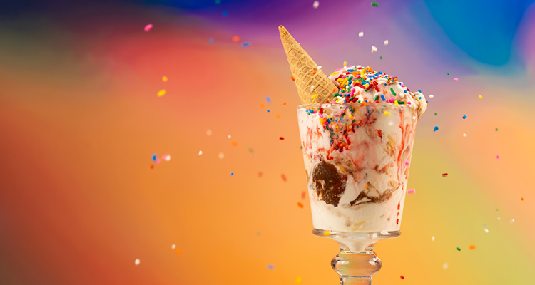 a classic ice cream sundae served in a footed glass cup