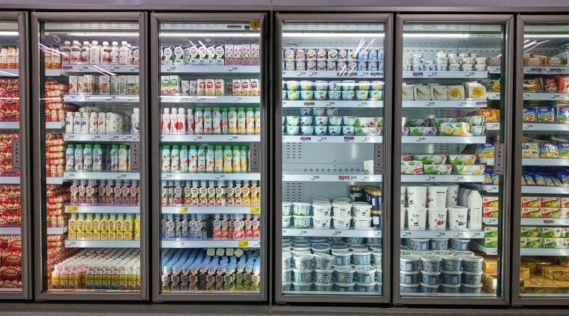 Beverages and desserts in refrigerator at storefront of supermarket