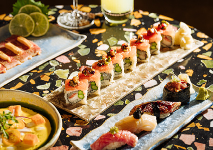  a vibrant assortment of Japanese sushi rolls, nigiri, and sashimi served on decorative ceramic plates