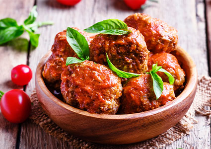 a bowl of savory Italian-style meatballs coated in a rich tomato sauce