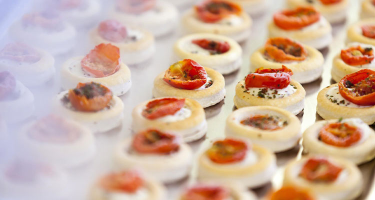 savory bite-sized canapés or tartlets topped with a creamy spread