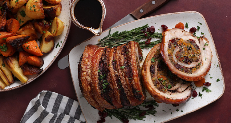 a sliced, golden-brown porchetta